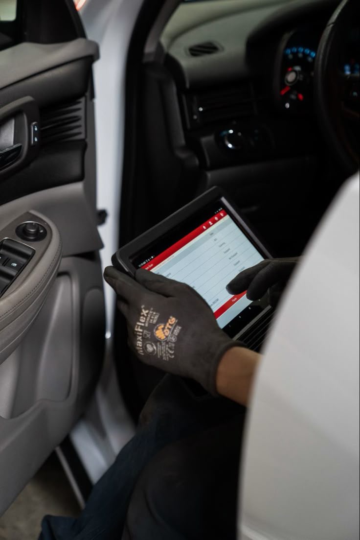 Диагностика ошибки Check Engine — мастер читает коды сканером в салоне автомобиля